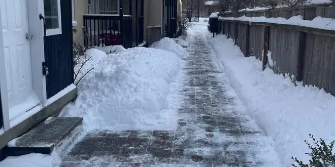 Heavy snow accumulation on a residential roof in winter