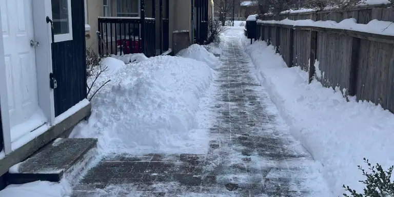 Heavy snow accumulation on a residential roof in winter
