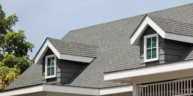 Roofing inspector examining a home's roof before a sale