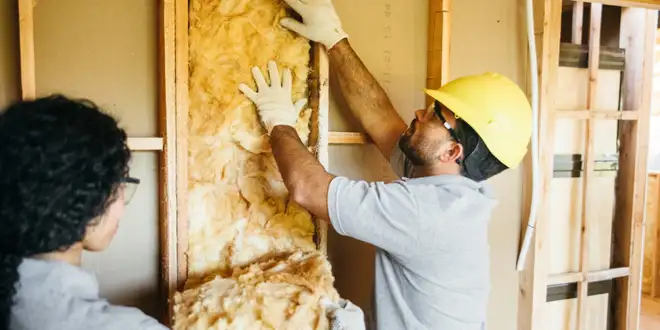 Attic insulation being installed to improve home comfort