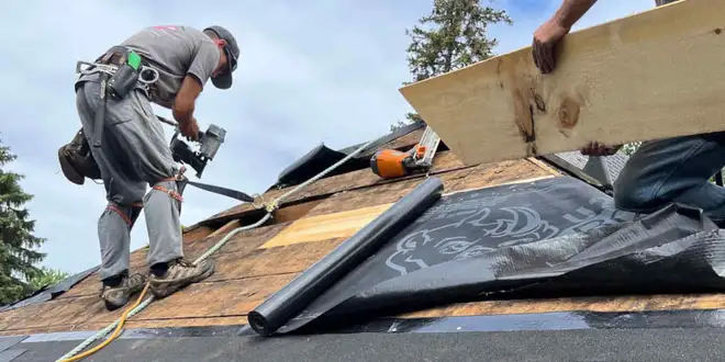 Roofer repairing a section of a commercial roof in Collingwood, Ontario