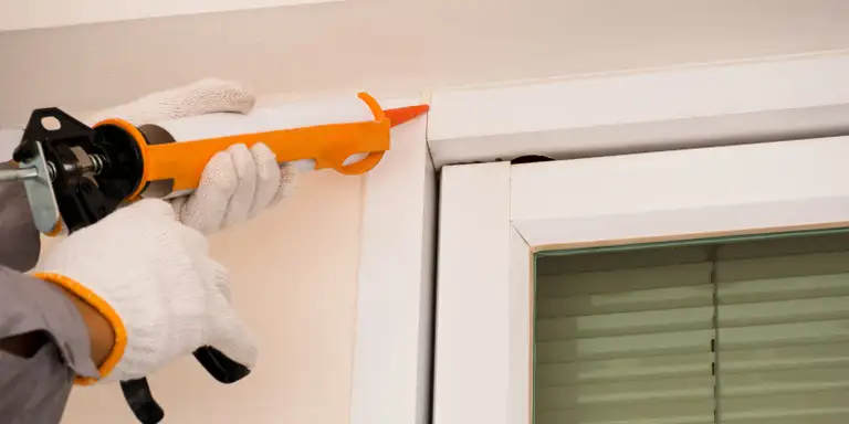 Exterior caulking applied around a roofline feature