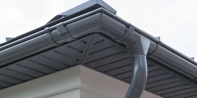 Old, worn eavestrough being removed and replaced on a Collingwood, Ontario home