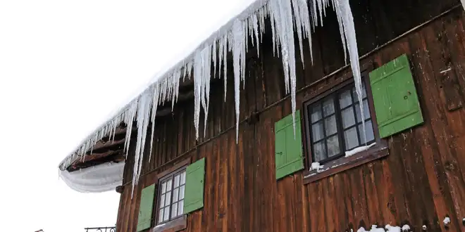 Ice buildup along the eaves of a Collingwood roof