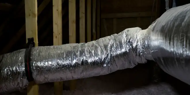 Blown-in insulation being applied in a home