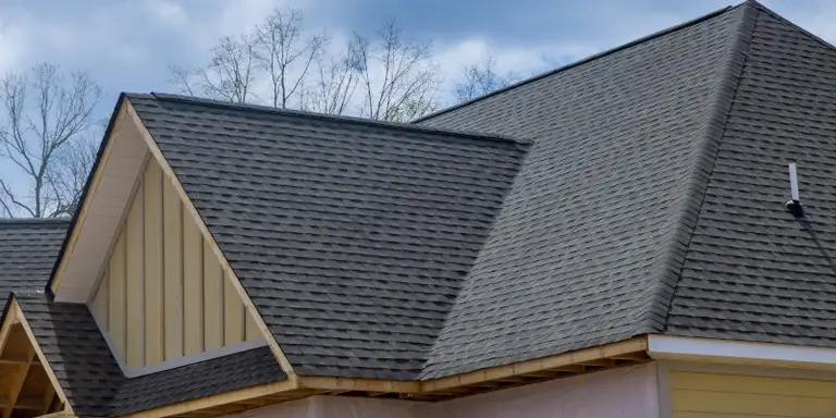 Assortment of residential rooftops showing different roofing materials