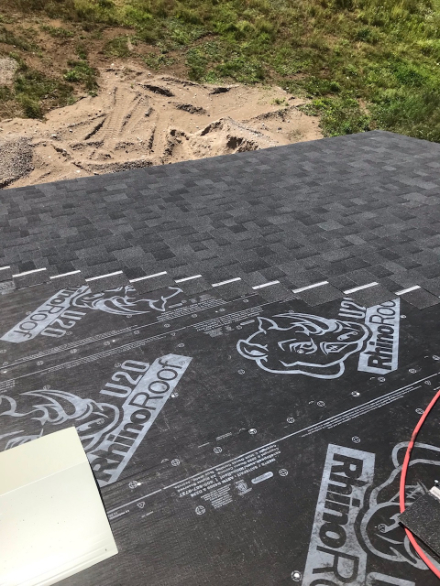 Roof deck with fresh underlayment being installed before new shingles